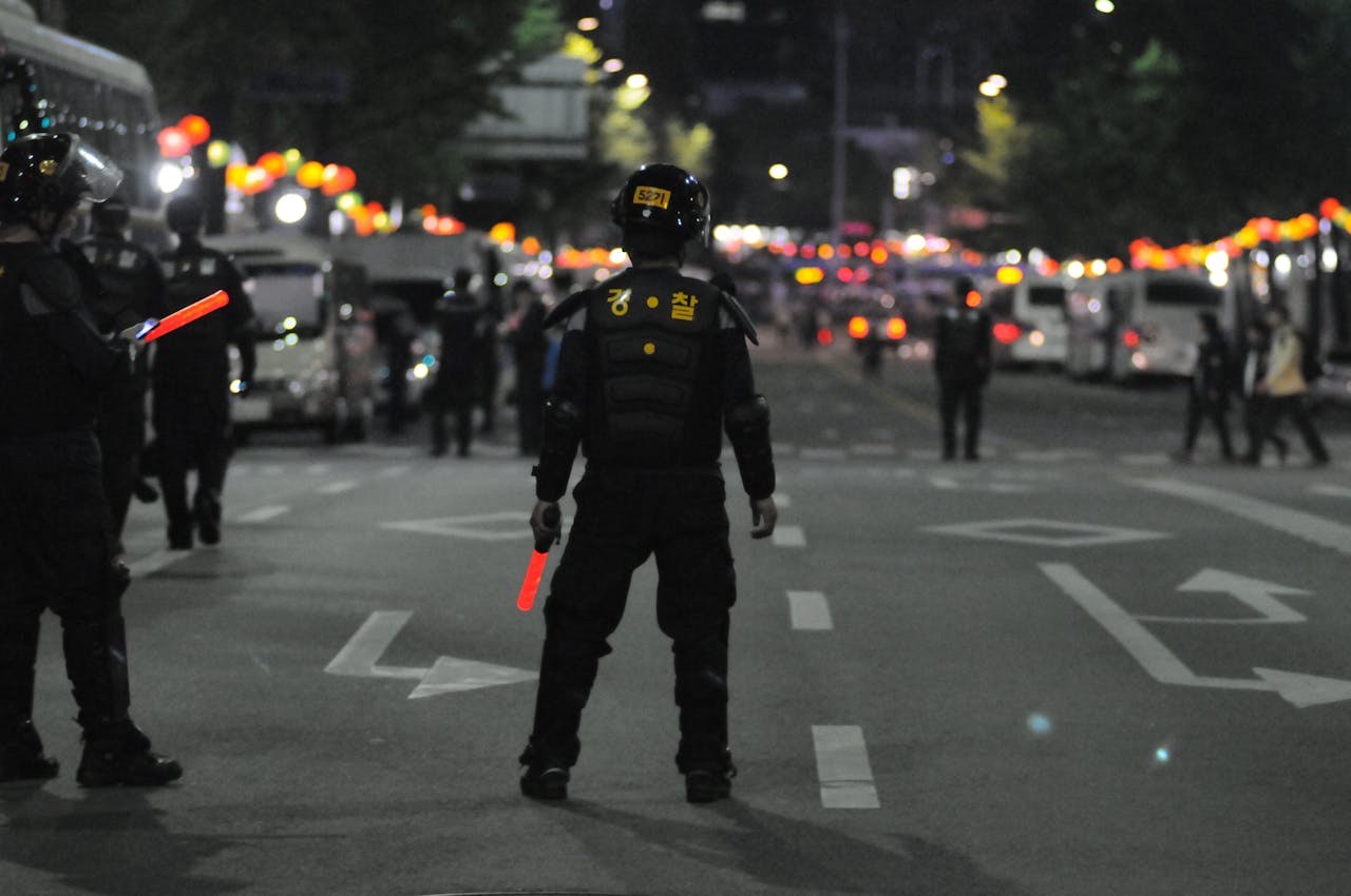 Police officers maintaining order during a night street patrol, ensuring public safety.